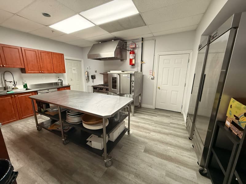 Full kitchen with prep table, oven and refrigeration used for life skills programming