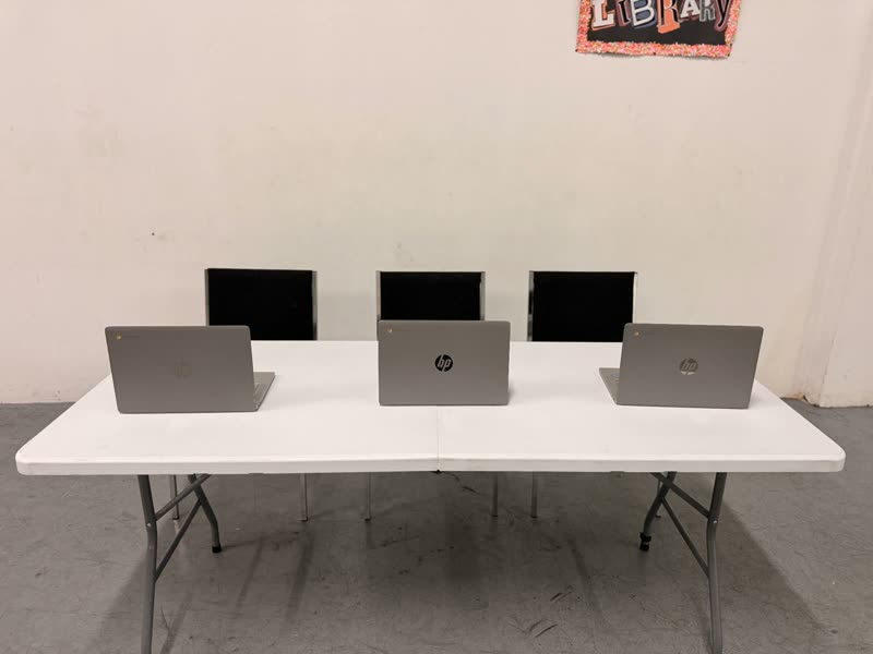 Table with laptops set up for the technology and library corner