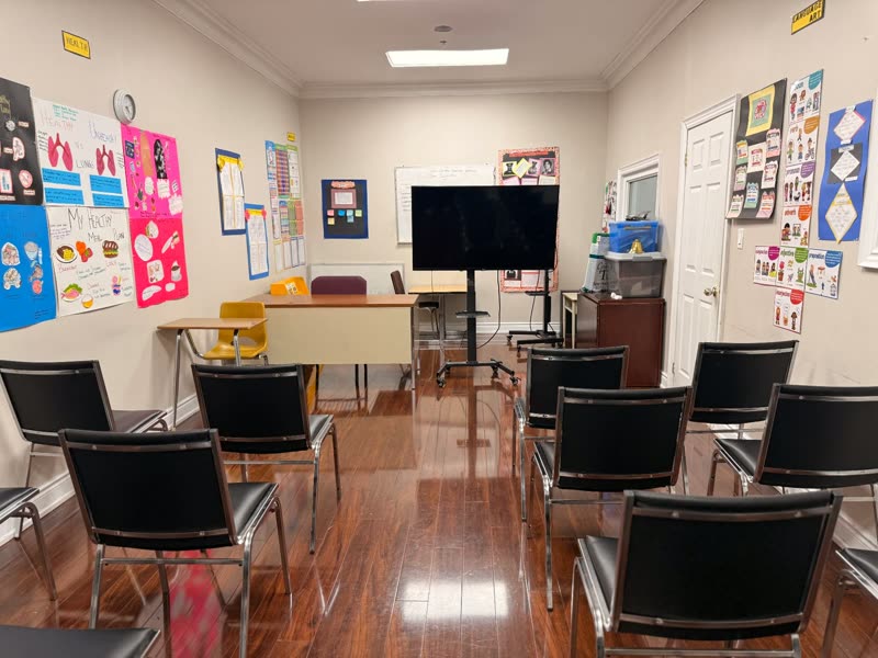 Learning room with seating, display screen and colourful educational posters